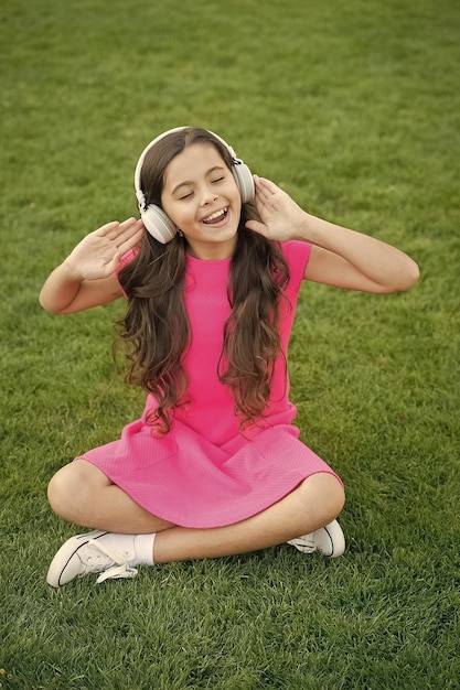 Practicing her singing Happy singer sing song outdoors Little girl enjoy singing to music Vocal exercises Enjoying solo singing Summer fun Discover your singing voice