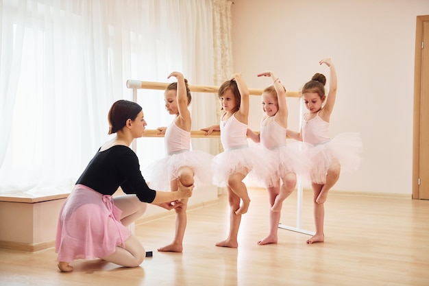 Practicing pose Little ballerinas preparing for performance