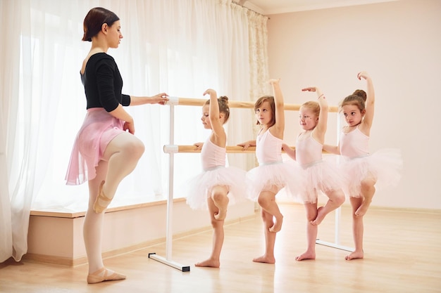 Practicing pose Little ballerinas preparing for performance