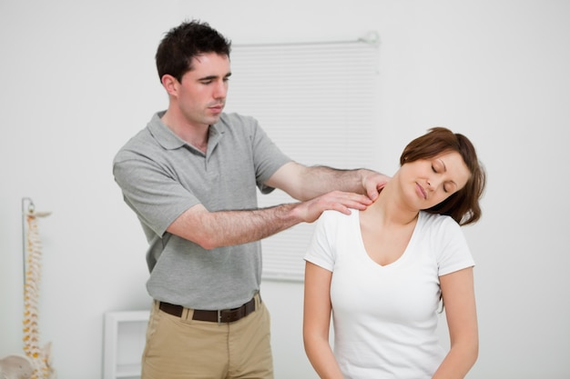 Practitioner looking at the neck of a patient