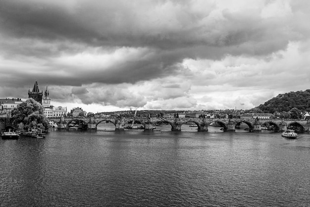 Prague charles bridge view from moldova river in b&amp;w
