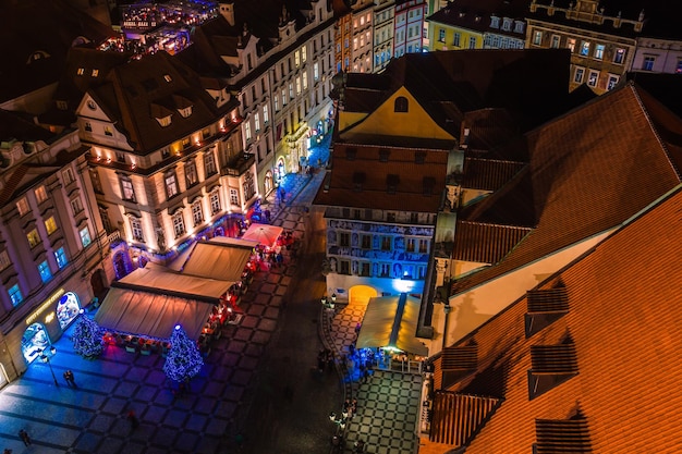 PRAGUE CZECH REPUBLIC DECEMBER 22 2015 View of prague rooftops with the blue illuminated spires in Old Town Prague