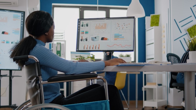 Pralyzed woman checking graphics from computer