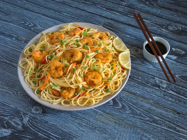 Prawn Schezwan Noodles with vegetables in a plate