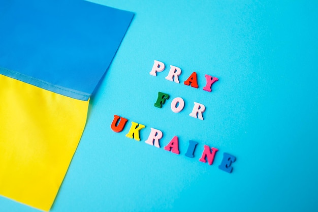 Pray for ukraine close up of ukrainian blue and yellow flag during war invasion in ukraine