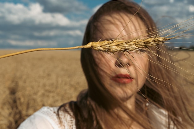 Pray for Ukraine Ukrainian girl in a wheat field A girl in a wheat field prays for peace in Ukraine Happy woman celebrating Independence Day