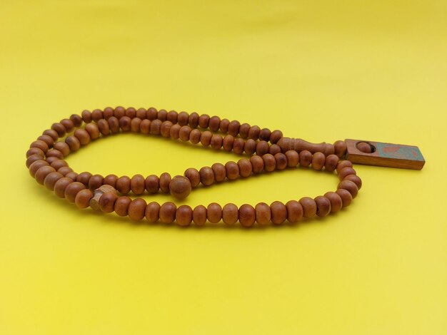 Photo prayer beads isolated on yellow background