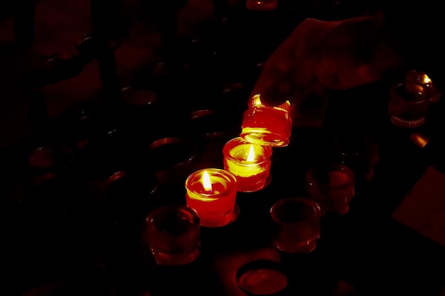 Prayer candles in votives and insence inside of a Catholic church