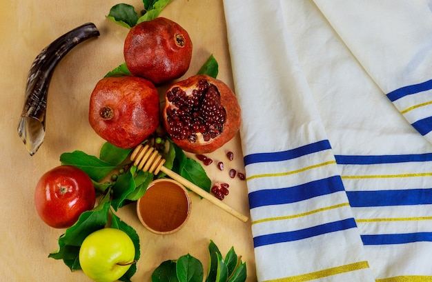 Prayer talit with shofar and traditional food for Rosh Hashanah. Jewish New Year.