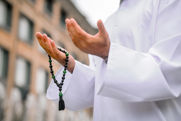 Prayer. Young bearded arabian man in traditional clothing praying