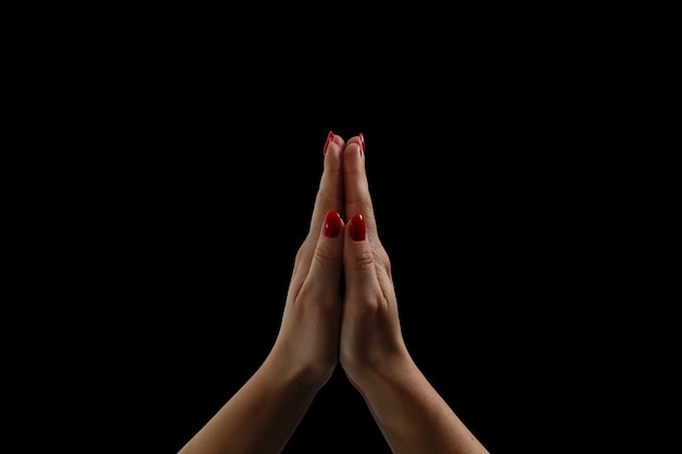 Praying hands on black background