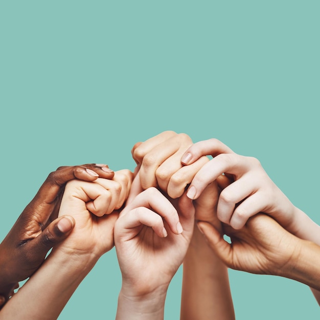 Praying hands and people united in prayer worship or community encouragement in studio Diversity pray and worship by group in church for praise help or hope blessing and God on green background