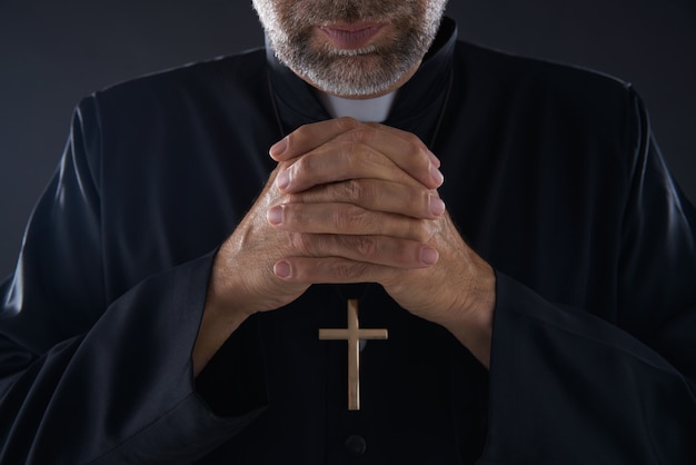 Praying hands priest portrait of male pastor