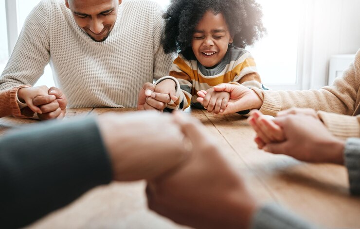 Photo praying together and family holding hands for worship support and church service happy hope and a father child and people with prayer faith and belief in religion grateful and praising