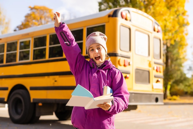 Pre teen girl getting on school bus.