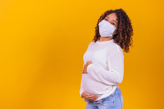 Pregnancy and infection concept. pregnant woman in medical face mask against flu and viruses. healthcare concept, copy space