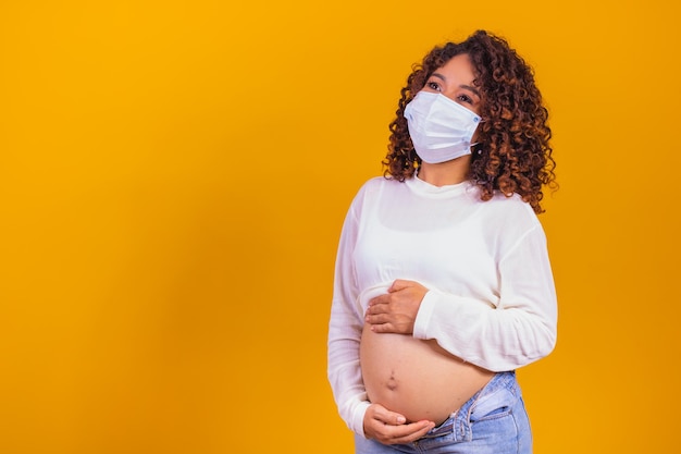 Pregnancy And Infection concept. Pregnant Woman in Medical Face Mask against flu and viruses. Healthcare concept, copy space.