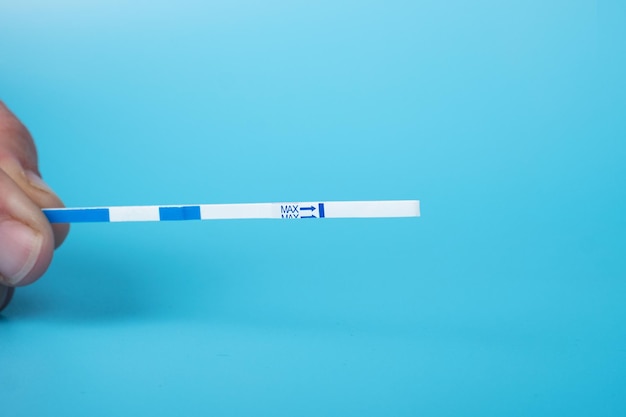 Pregnancy medical test closeup on a blue background