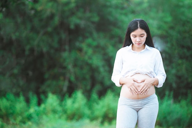 Pregnancy motherhood people and expectation concept close up of happy pregnant woman with big belly