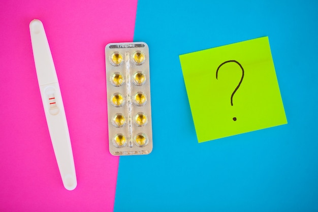 Pregnancy planning concep. Pregnancy test positive with two stripes and contraceptive pill