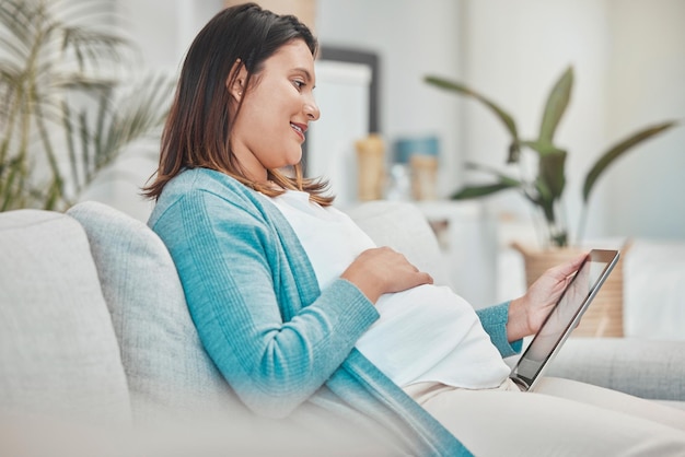 Pregnancy planning relax and woman with a tablet streaming movies and reading information on baby health Pregnant research healthcare and mother with social media on tech during maternity leave