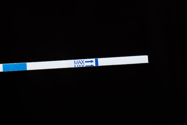 Pregnancy test closeup on a dark background