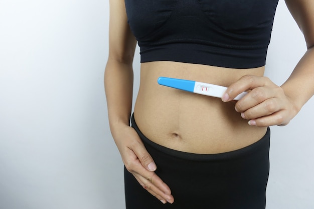 Pregnancy test tool in woman's hand