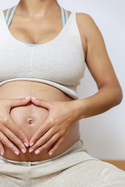 Pregnancy yoga Young woman practices yoga and pilates at home