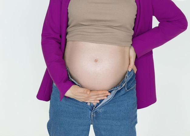 Pregnant belly against white background unrecognizable women support with hands pregnant belly pain