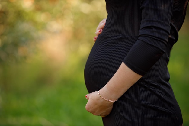 Pregnant belly and mom's hands