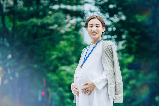 Pregnant business woman standing outdoors