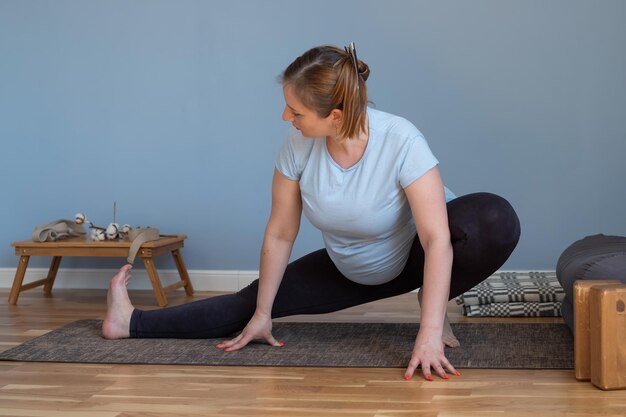 Pregnant caucasian woman standing in yoga asana