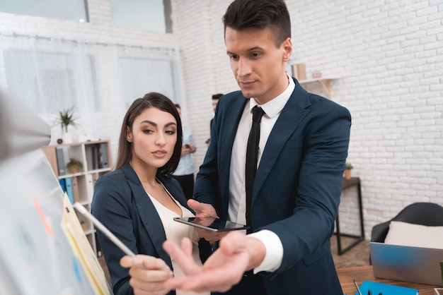 Pregnant Colleague Discussing Work in Office