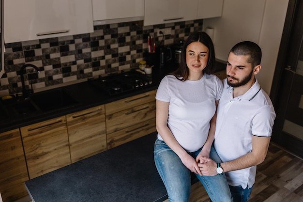 Pregnant couple Happy family Pregnant woman with husband in the kitchen