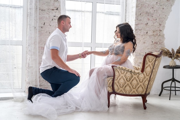 Pregnant couple looking tenderly waiting for a baby