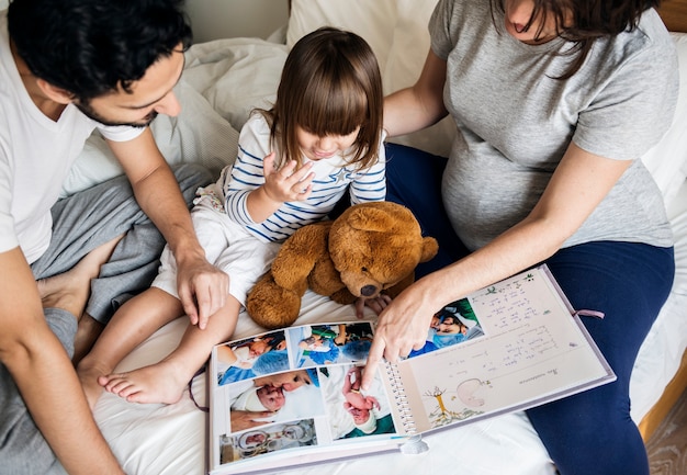 Pregnant family looking through a family photo album