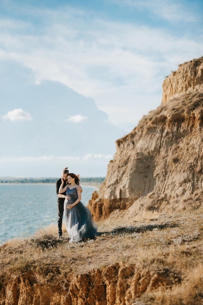 Pregnant girl and boyfriend on high hills