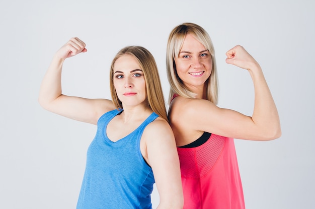 Pregnant girl and her friend are engaged in fitness