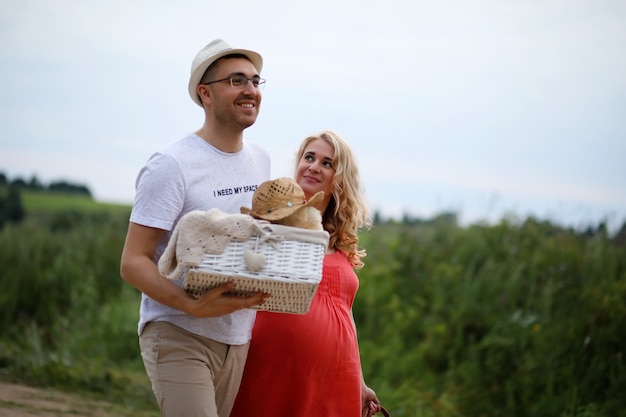 Pregnant girl with big belly and young man in park