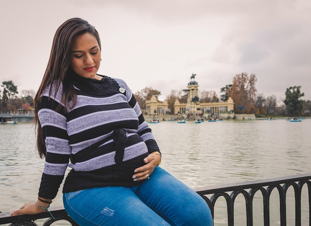 Pregnant Latina woman in a lake