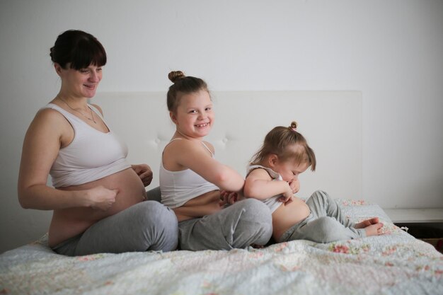 Photo pregnant mother with daughters life style in a real interior the concept of large families