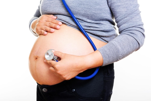 Pregnant woman being examine with stethoscope Pregnancy concept