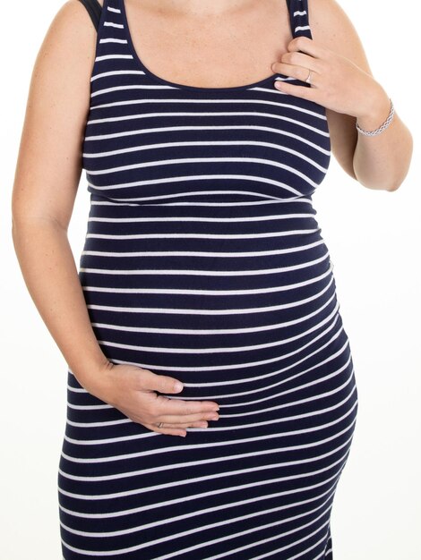 Pregnant woman belly in fashion striped dress hands on tummy belly body