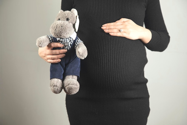 Pregnant woman belly with toy