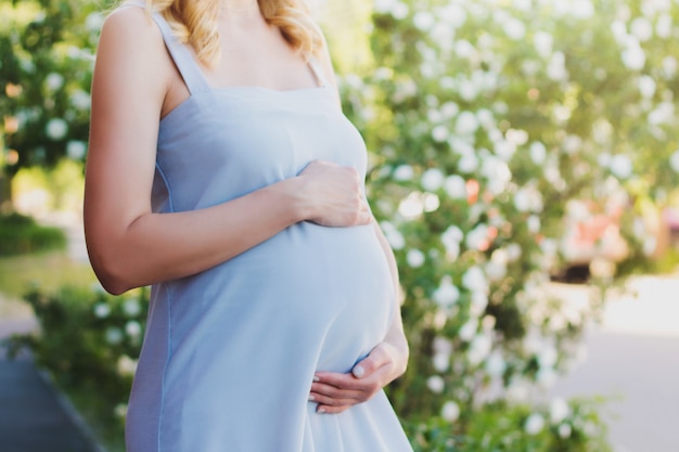 A pregnant woman in a blue dress 