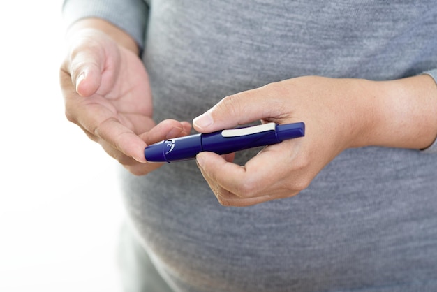 Pregnant woman checking blood sugar level Gestational diabetes