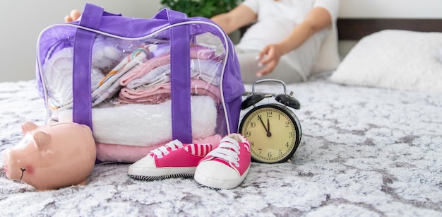 A pregnant woman collects baby things Selective focus Home