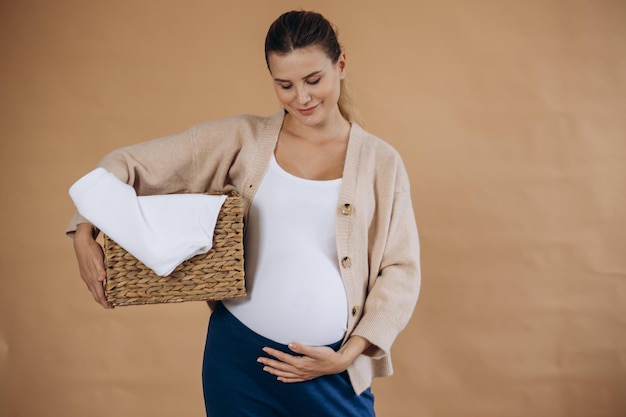 Pregnant woman doing laundry at home