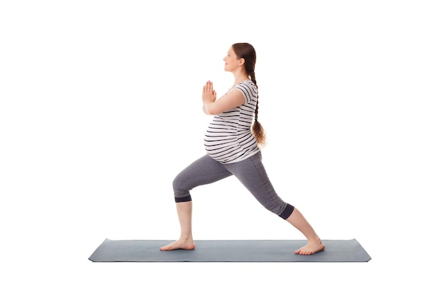 Pregnant woman doing yoga asana virabhadrasana