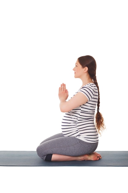 Photo pregnant woman doing yoga asana virasana isolated on white